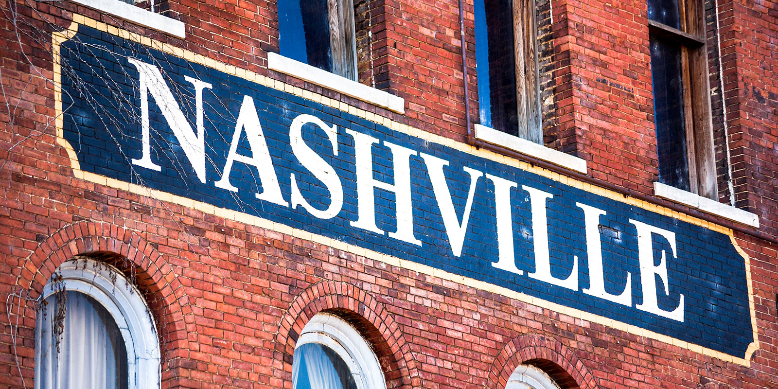 City of Nashville sign painted on the side of a brick building